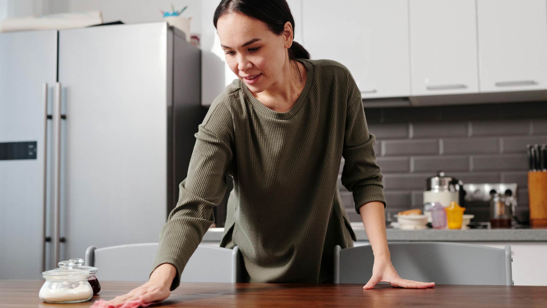 person cleaning as they go