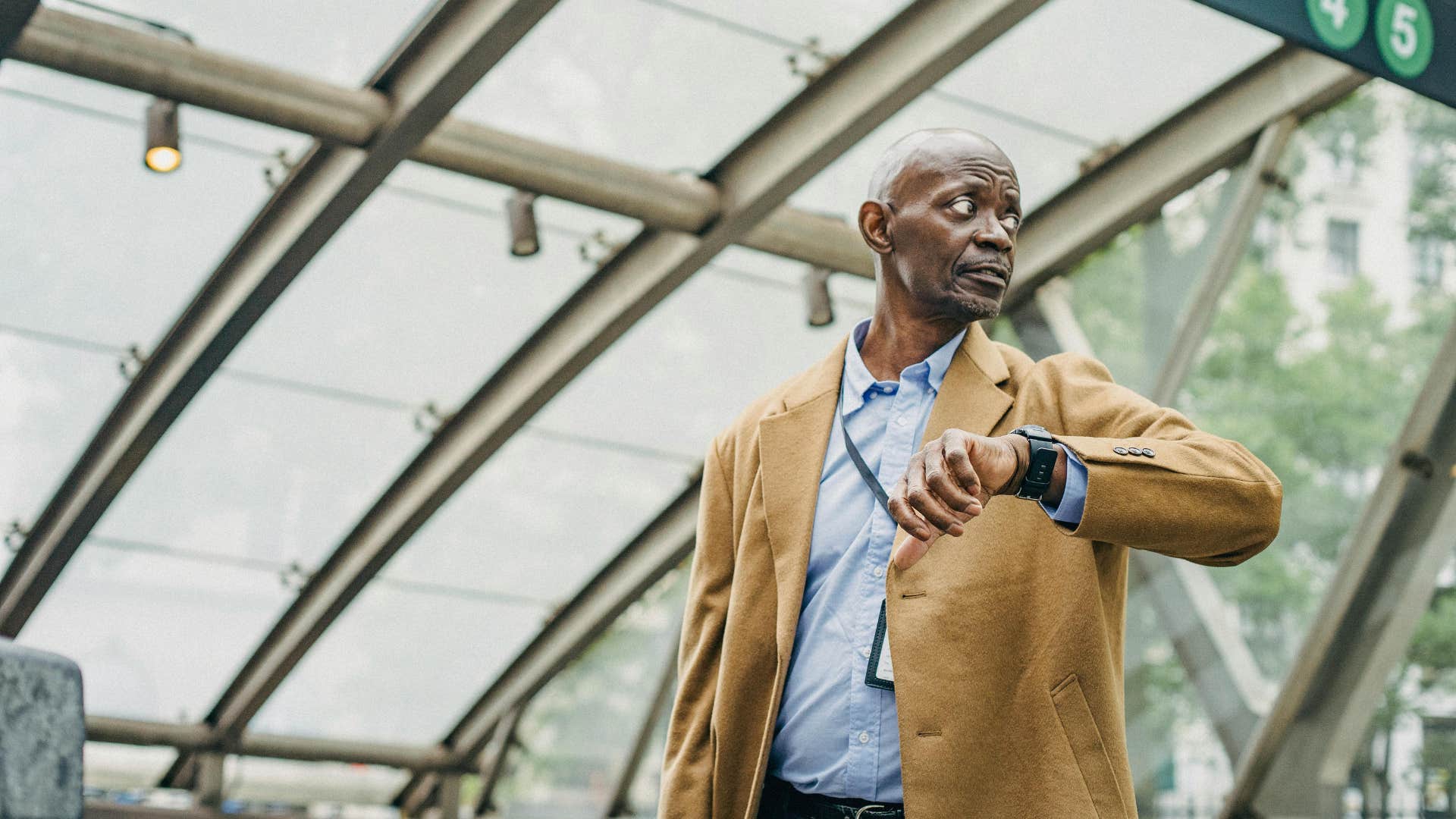 man who treats time like a loose suggestion looking at his watch