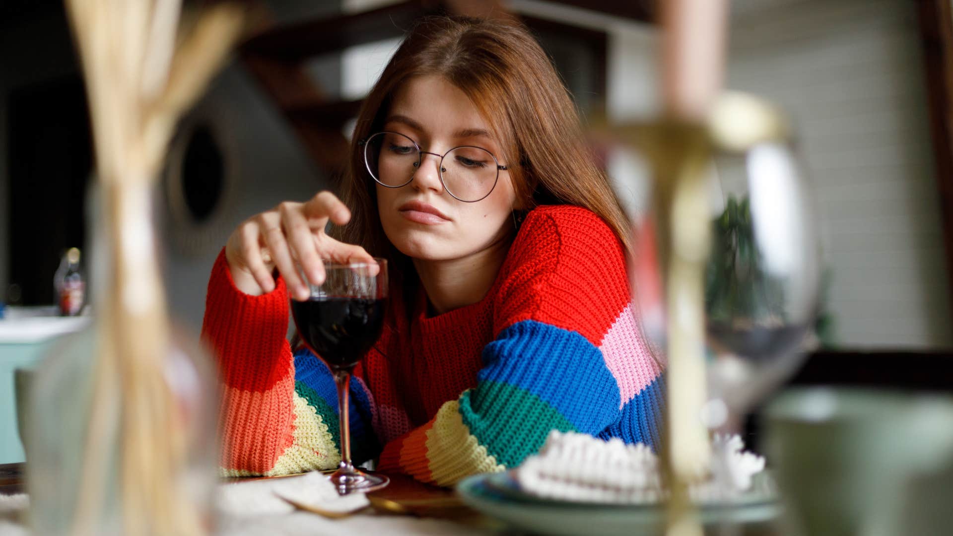 bored woman sitting with glass of wine