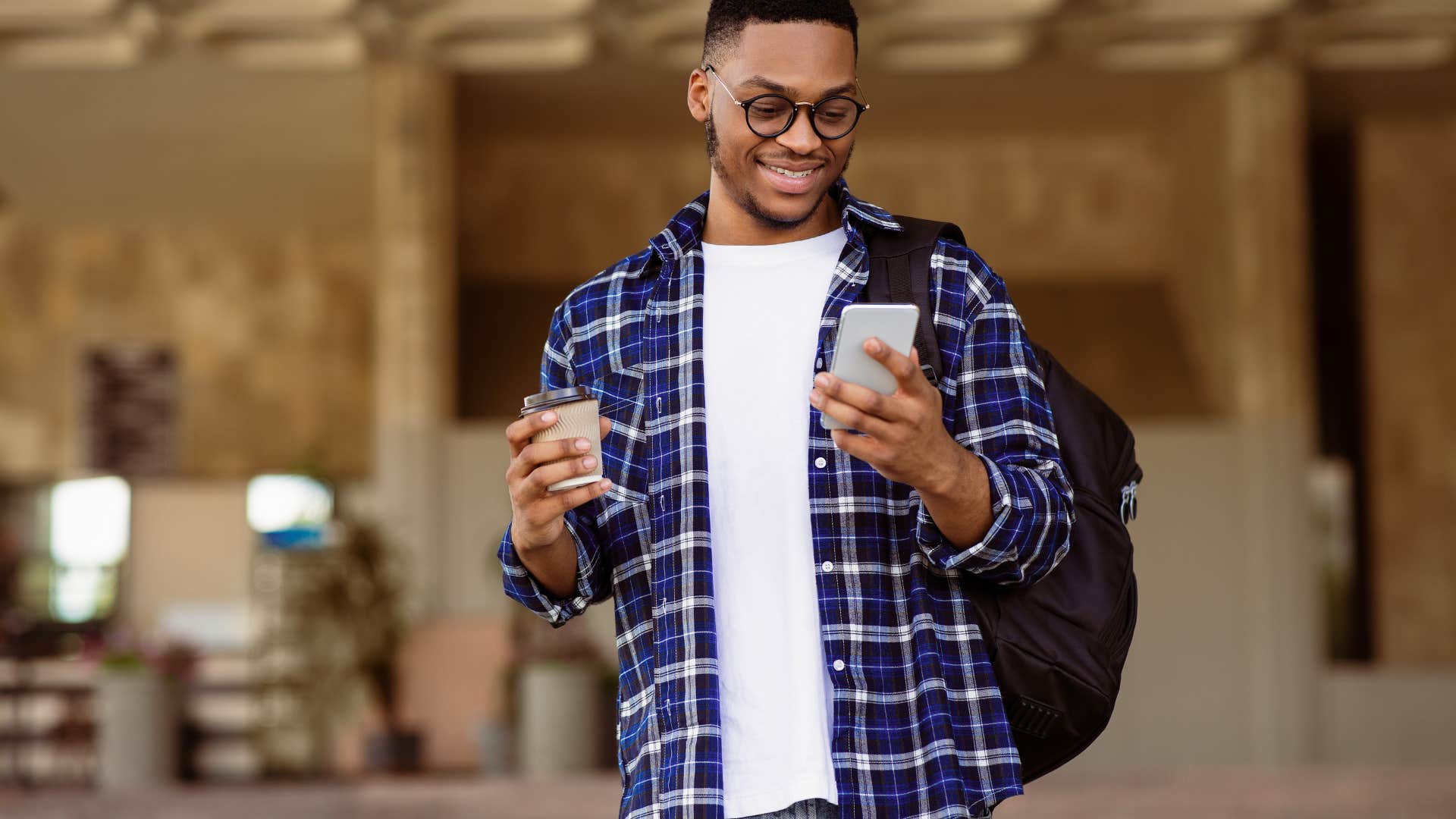 man looking at his phone while out in public