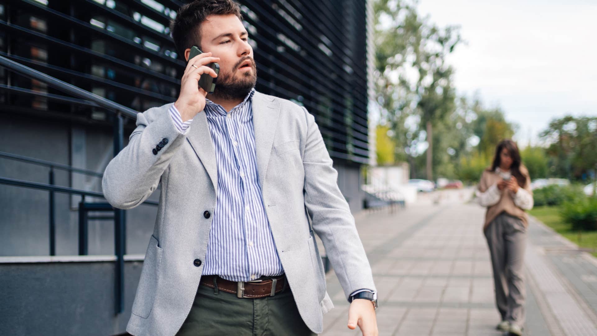 goal-oriented man talking on the phone walking outside
