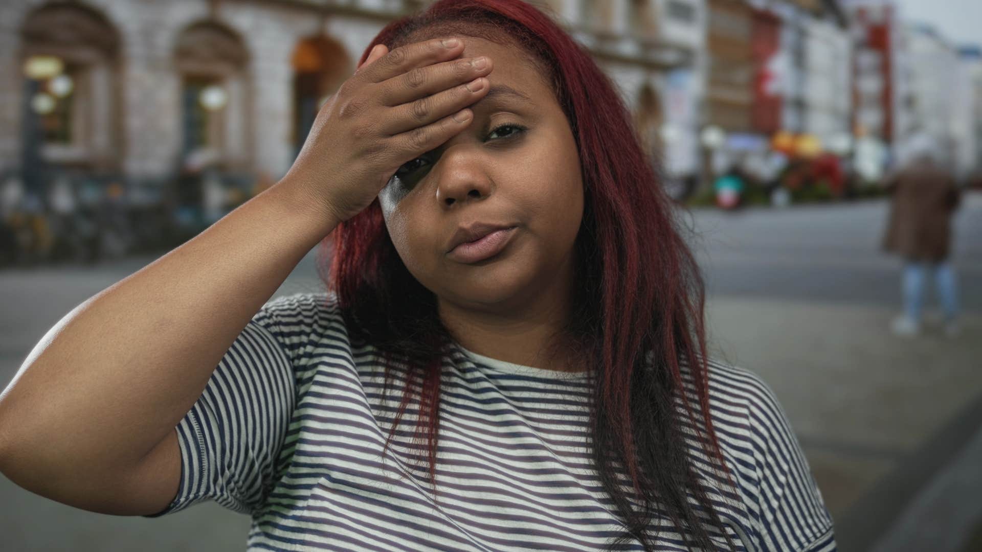 introverted woman looking annoyed standing outside