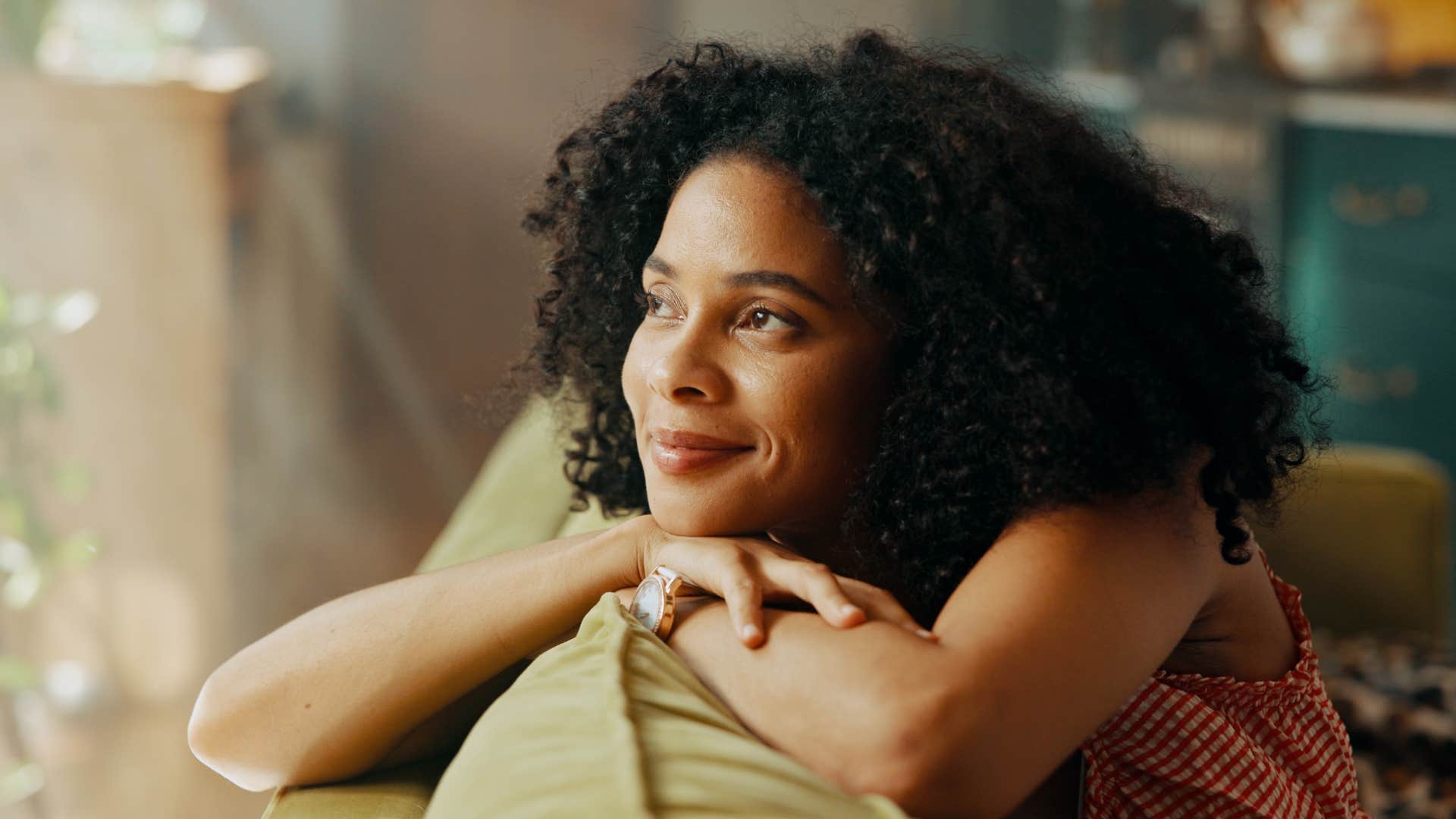 woman prioritizing comfort sitting on couch thinking