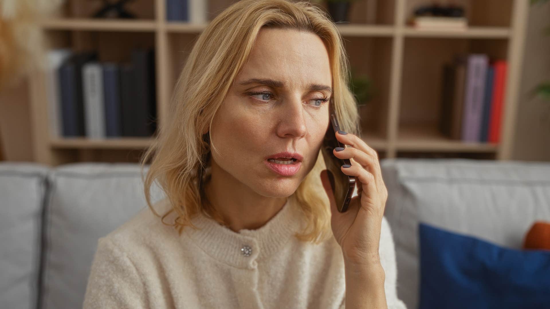 woman feeling judged talking on the phone with parents