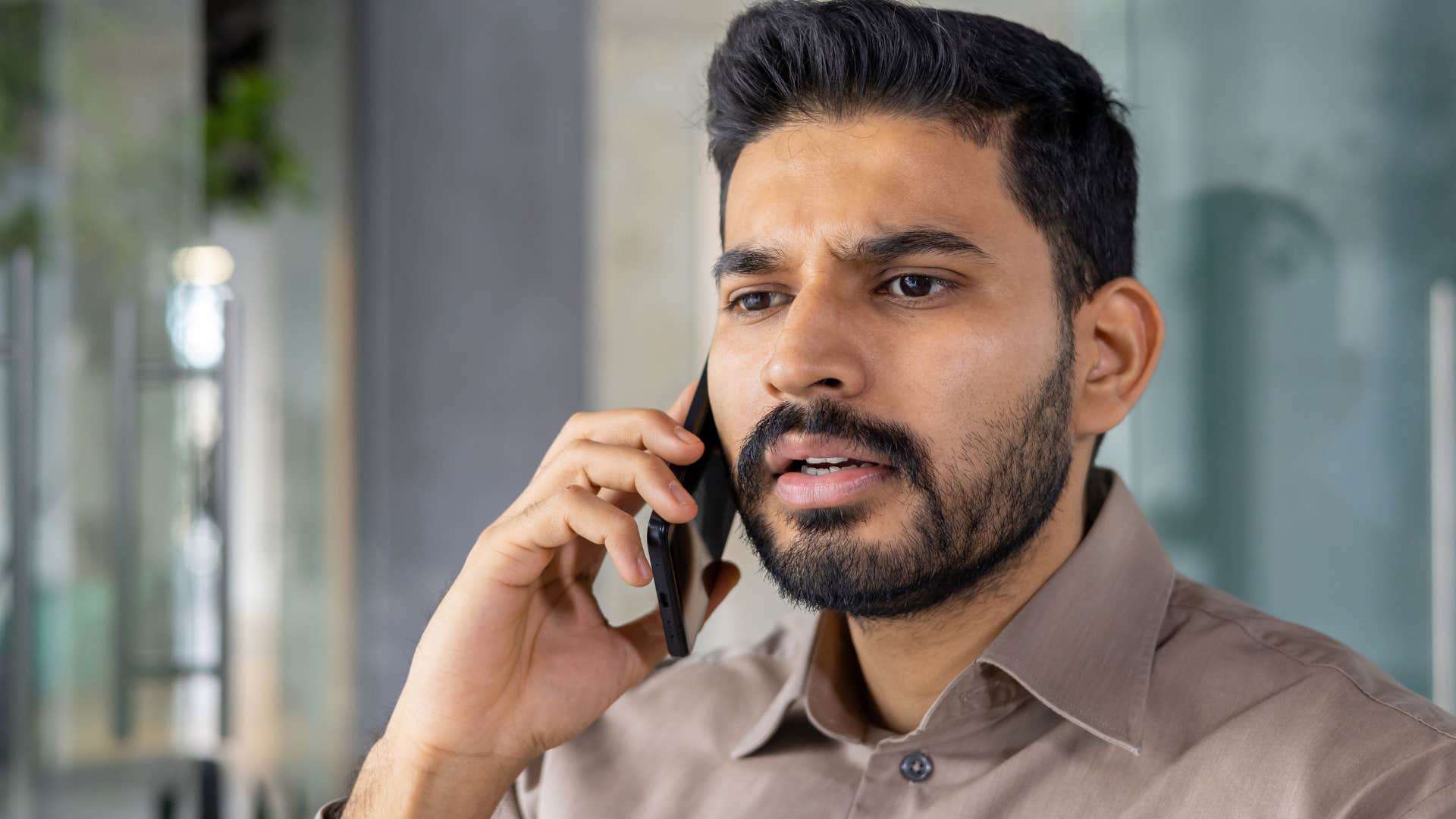 man who's hiding something from his parents talking on the phone