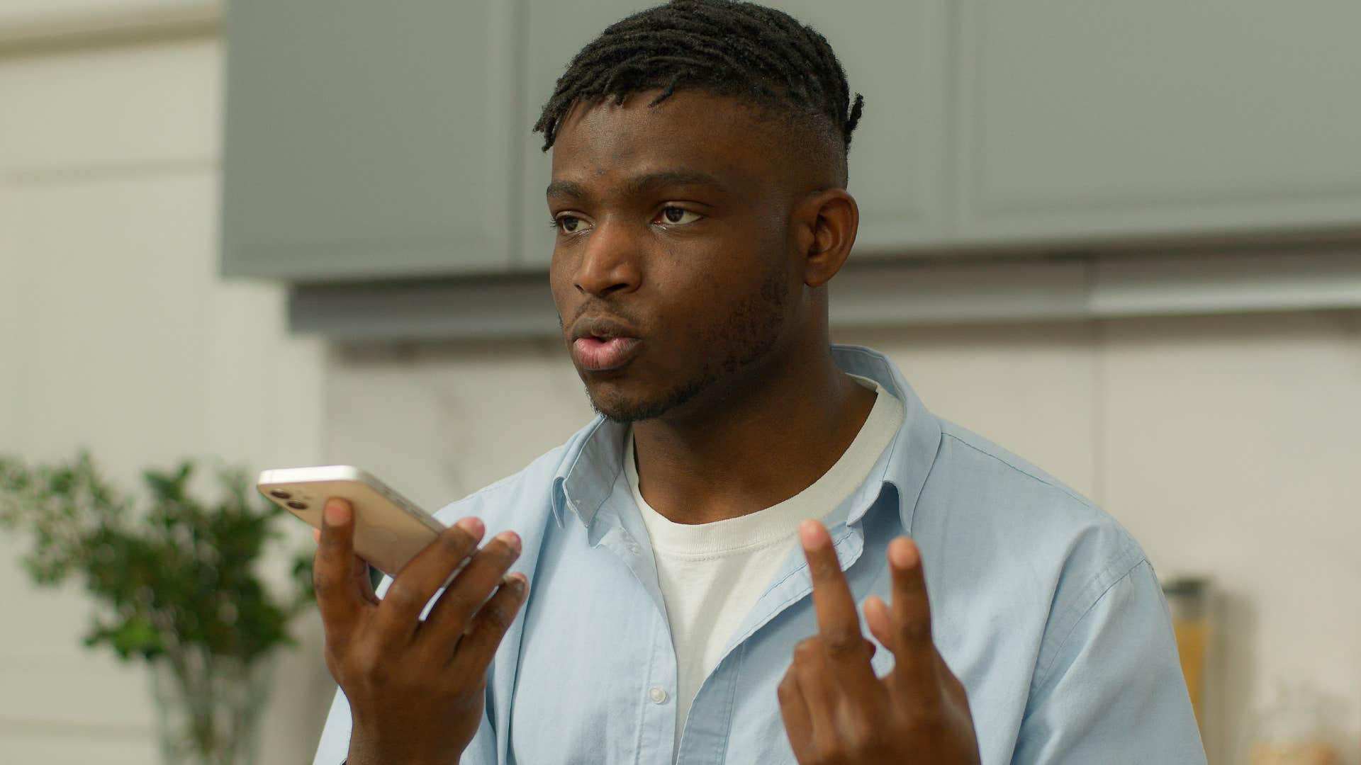 man receiving unsolicited advice from parents through the phone