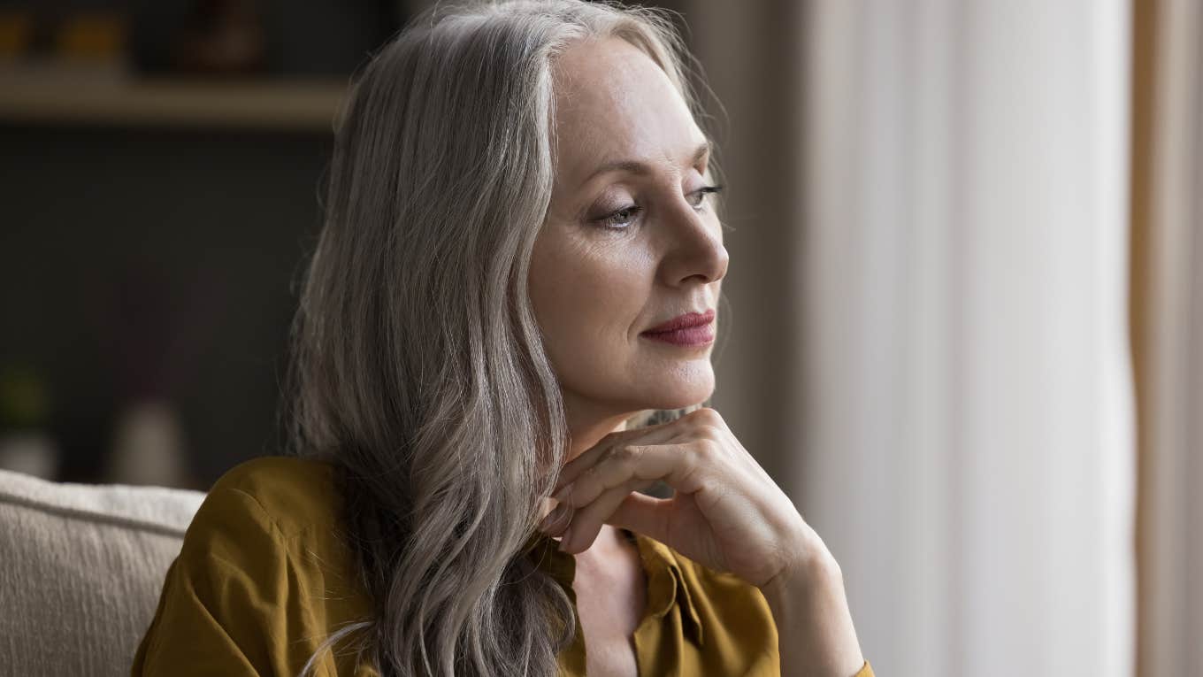 older woman sitting quietly in her home