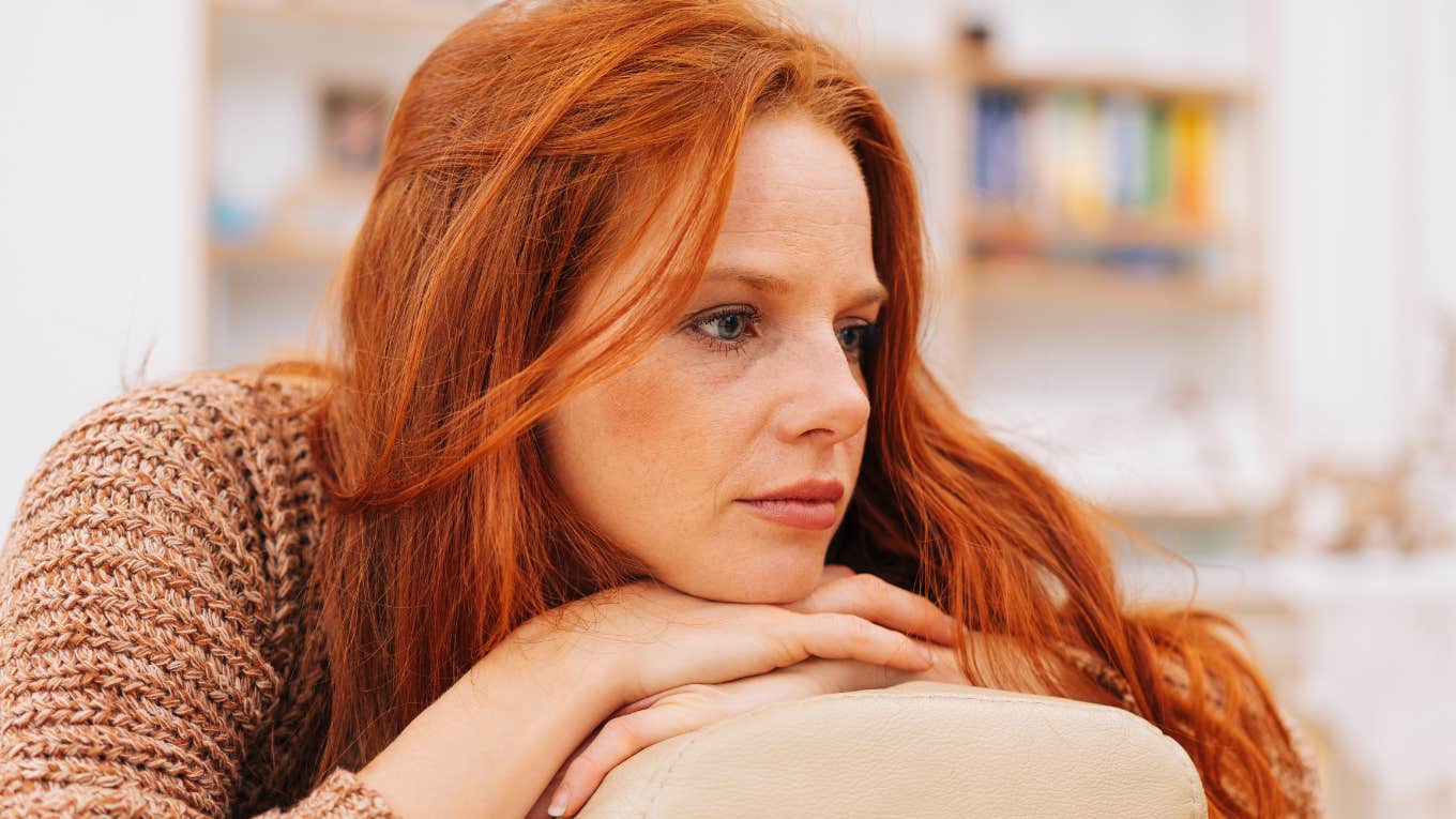 sad woman on couch thinking about her childhood