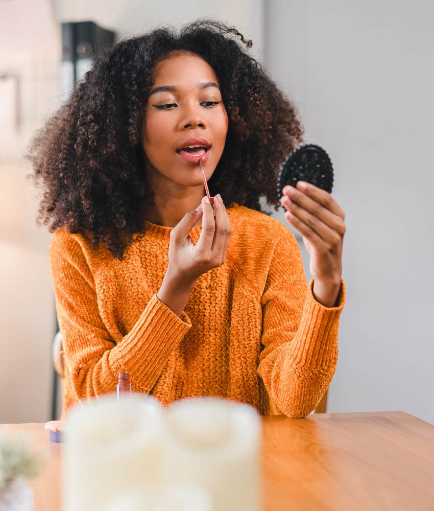 Person fighting depression puts on makeup