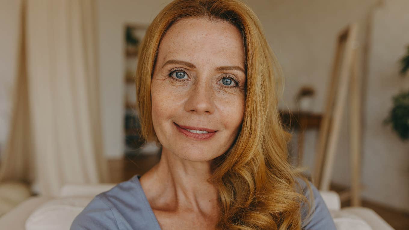 older woman sitting in living room with same decor