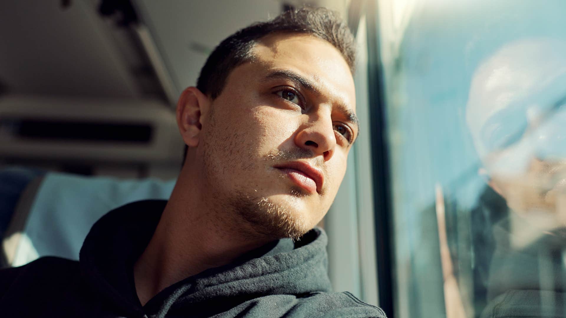 self-aware man sitting on a bus