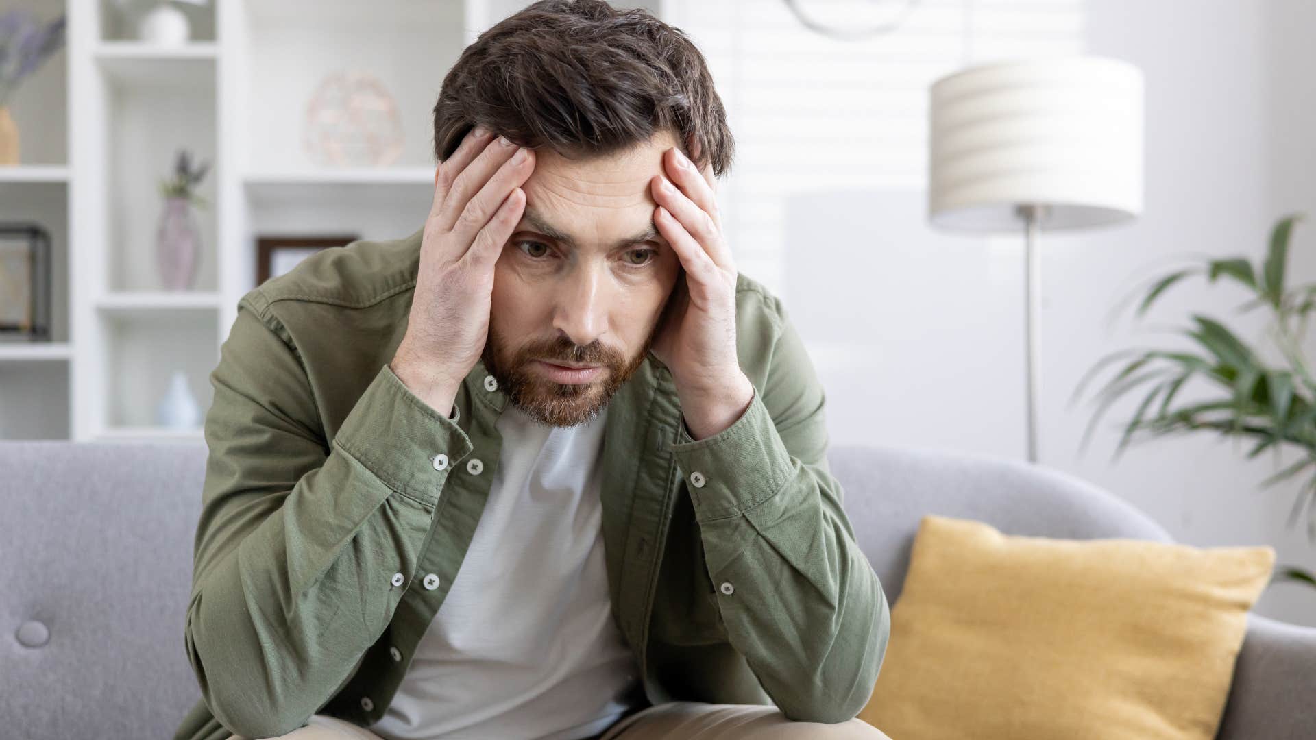 man with chronic stress sitting at home thinking