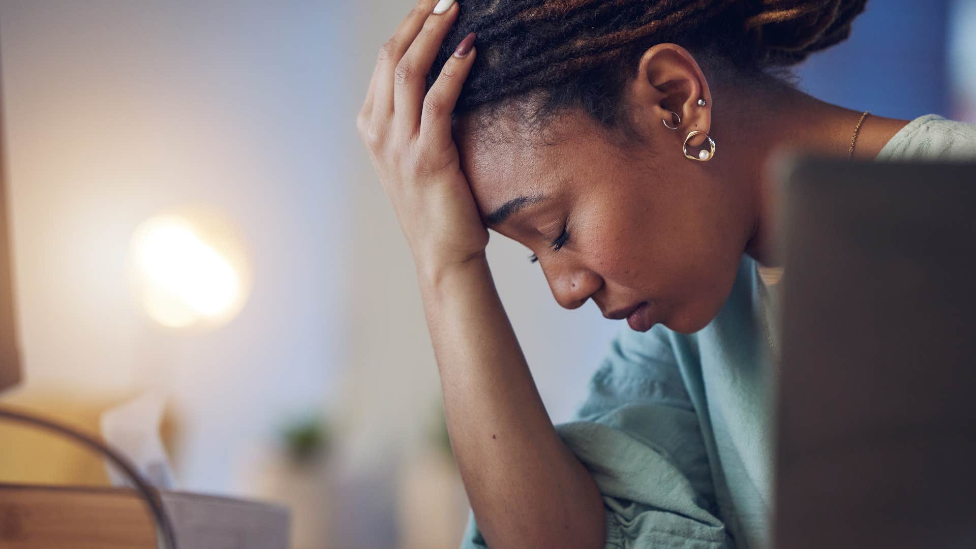 woman suffering from decision fatigue holding her head