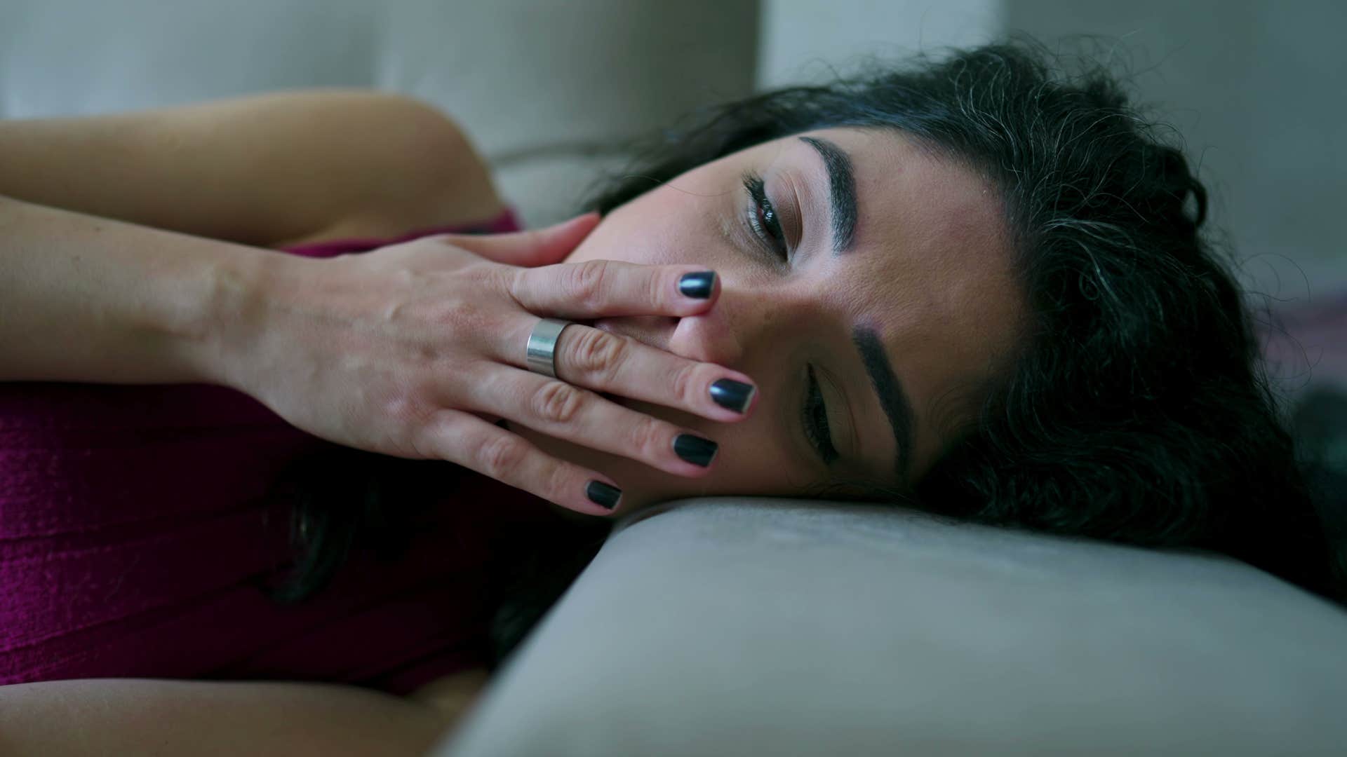 sad woman laying down dealing with hopelessness