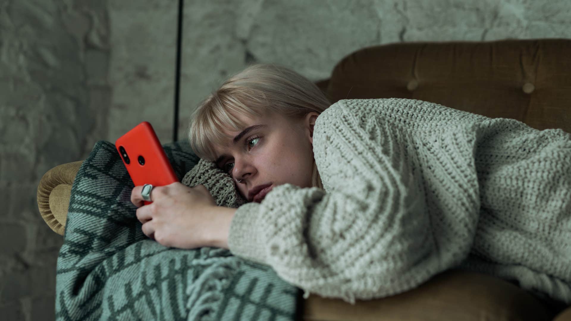 woman dealing with loneliness scrolling on her phone