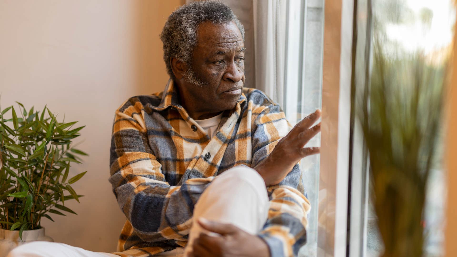 man who's experienced a shift in identity sitting at home alone