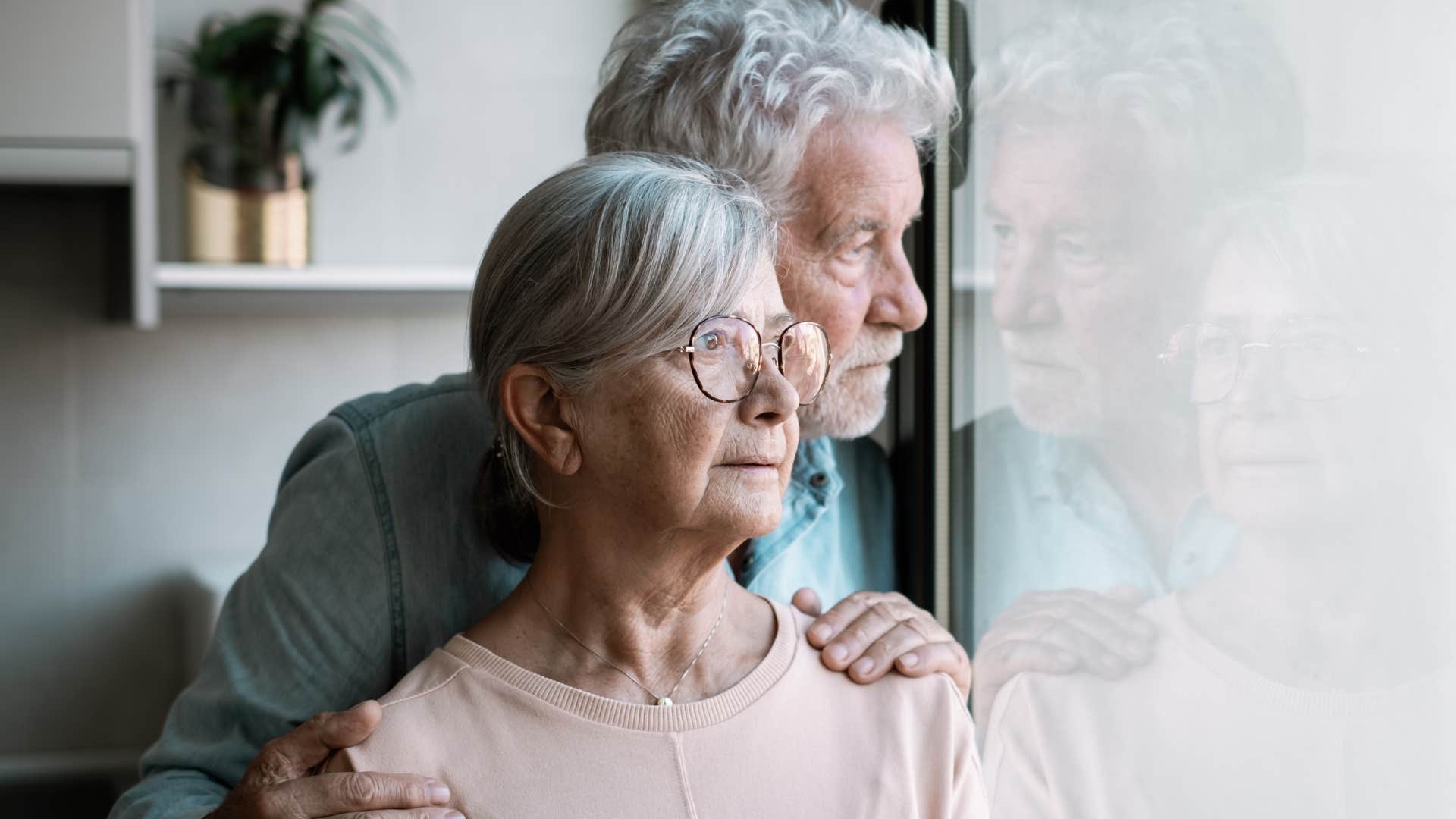 older couple with social anxiety looking out a window