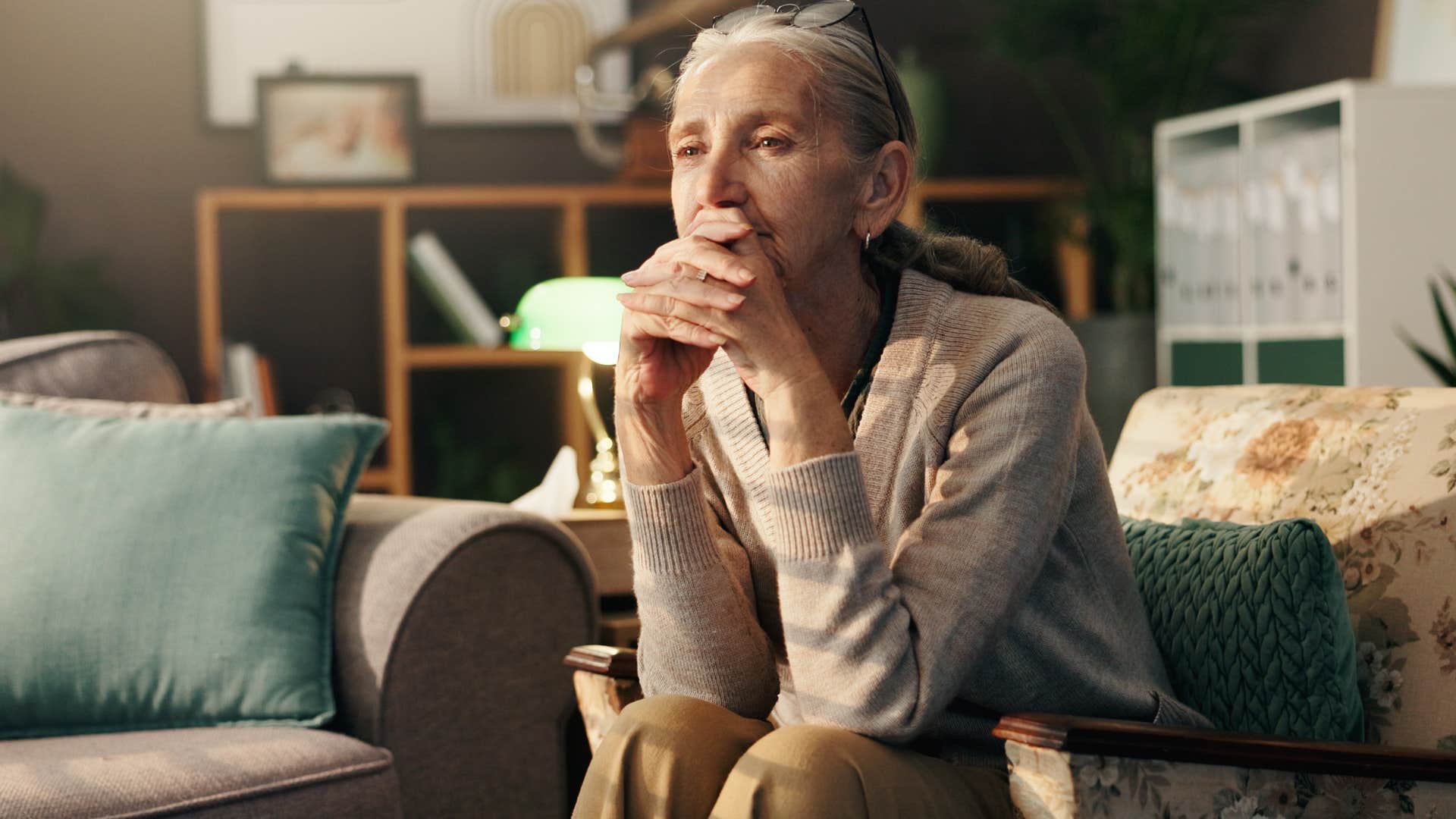 older woman who's lost touch with their friends sitting at home alone