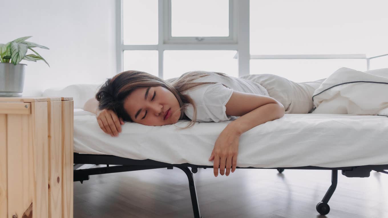 young woman sleeping on her stomach 