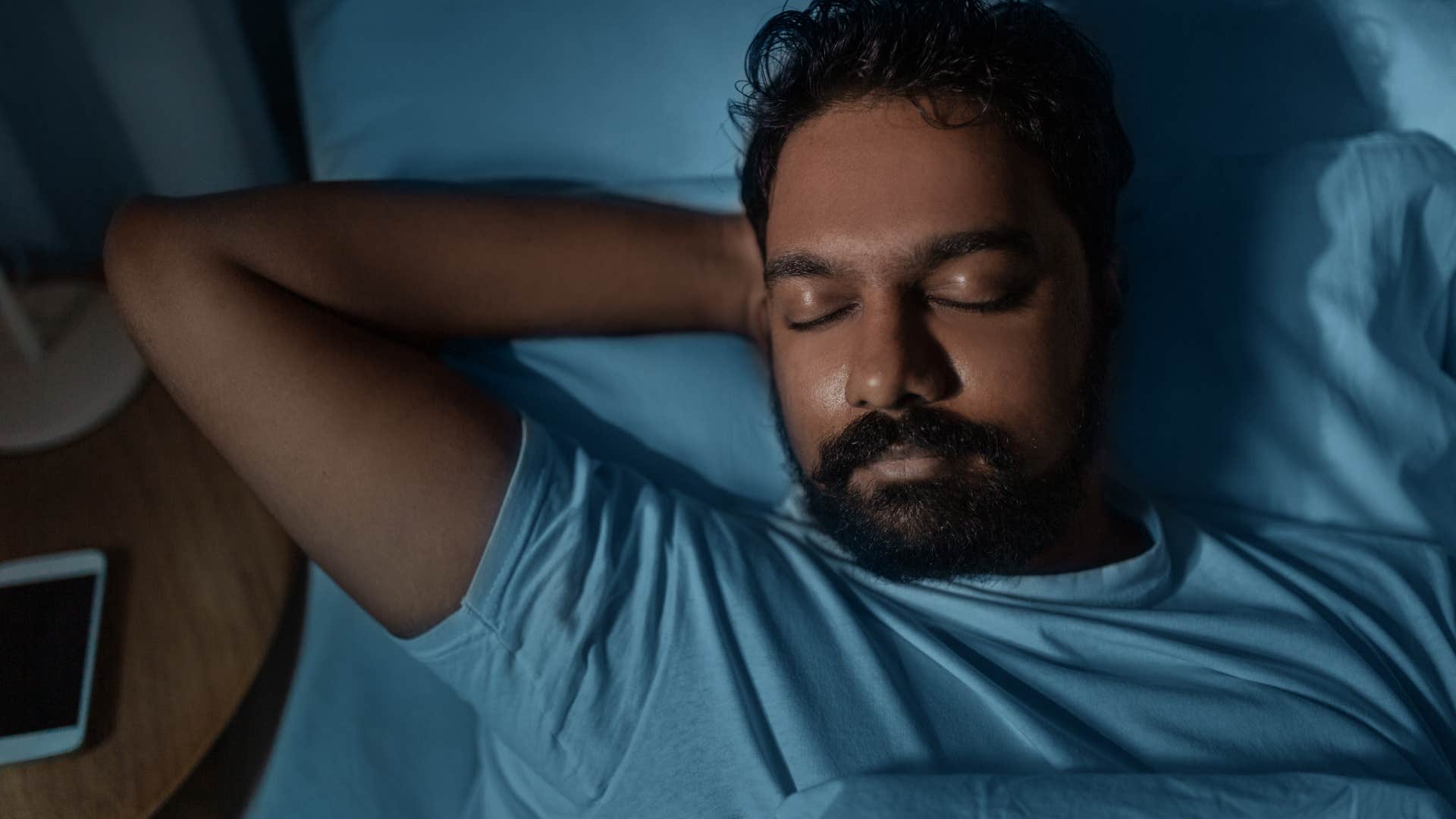 internally strong man sleeping in bed