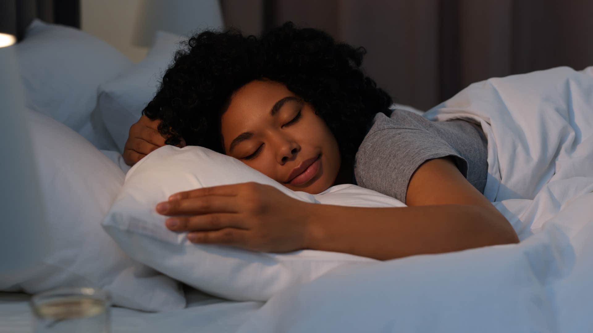 woman who's a problem-solver under pressure lying in bed asleep