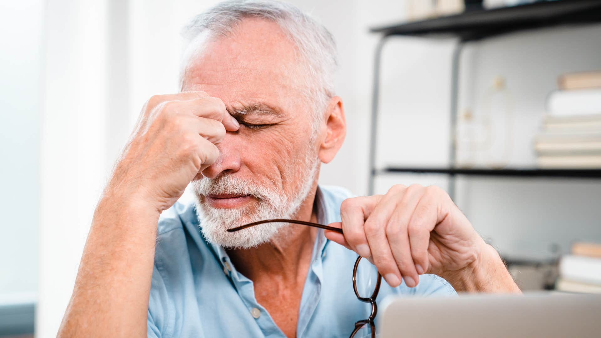 anxious burnt out man looking stressed at home