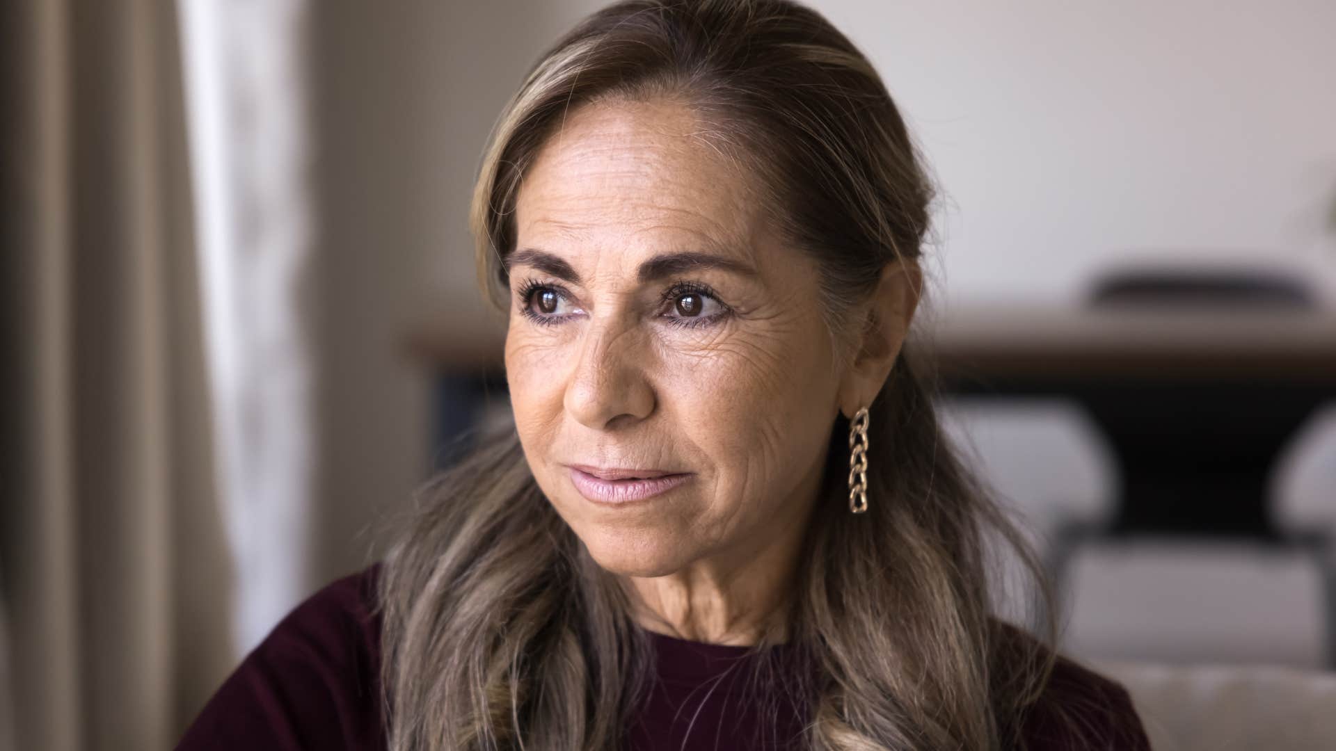 woman who's feeling emotionally fragile looking out a window