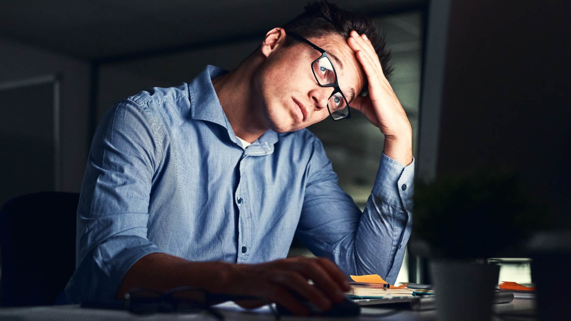 man sitting alone with his thoughts at night