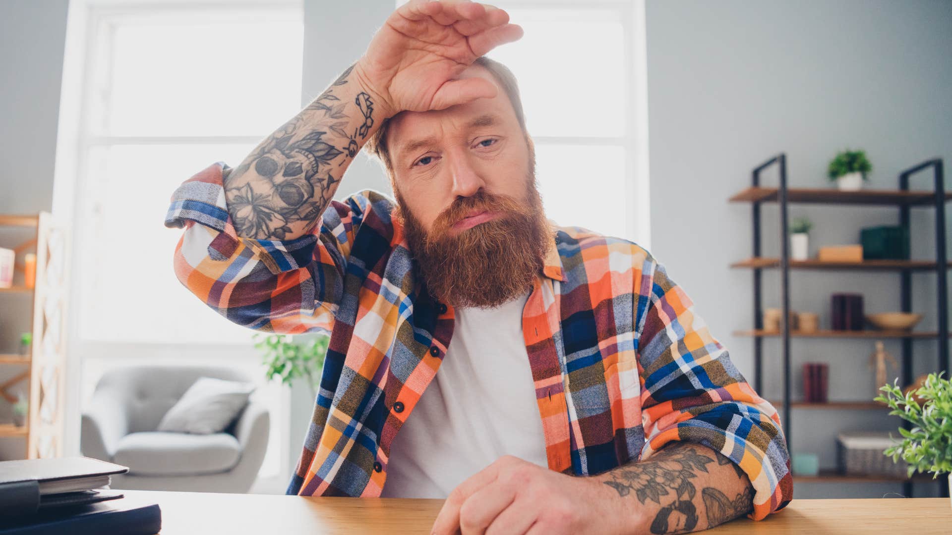 tired man feeling exhausted at work