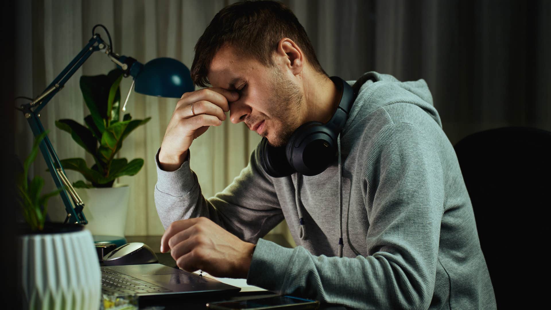 man experiencing burnout looking tired at desk