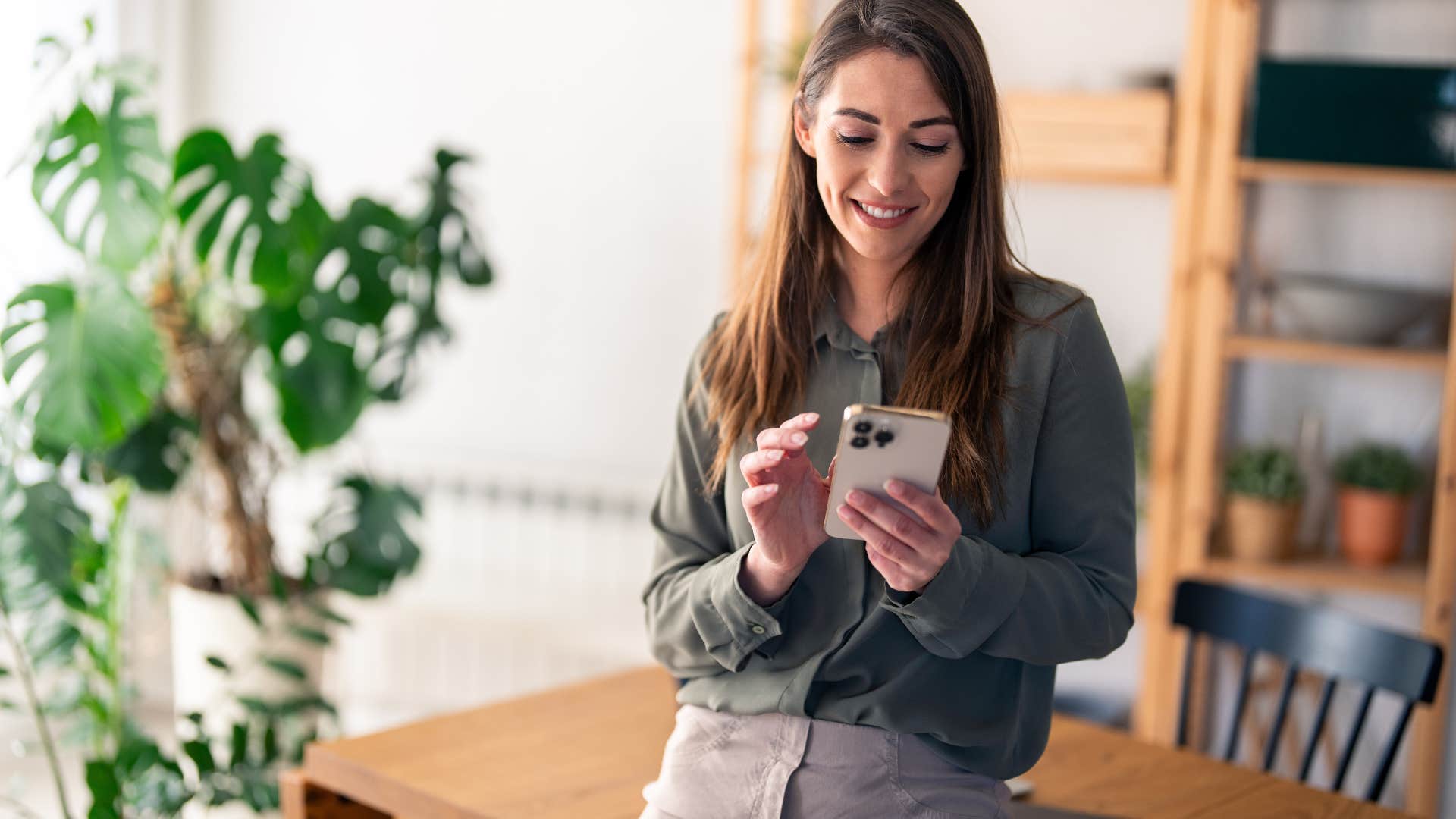 woman looking at her phone to track her spending