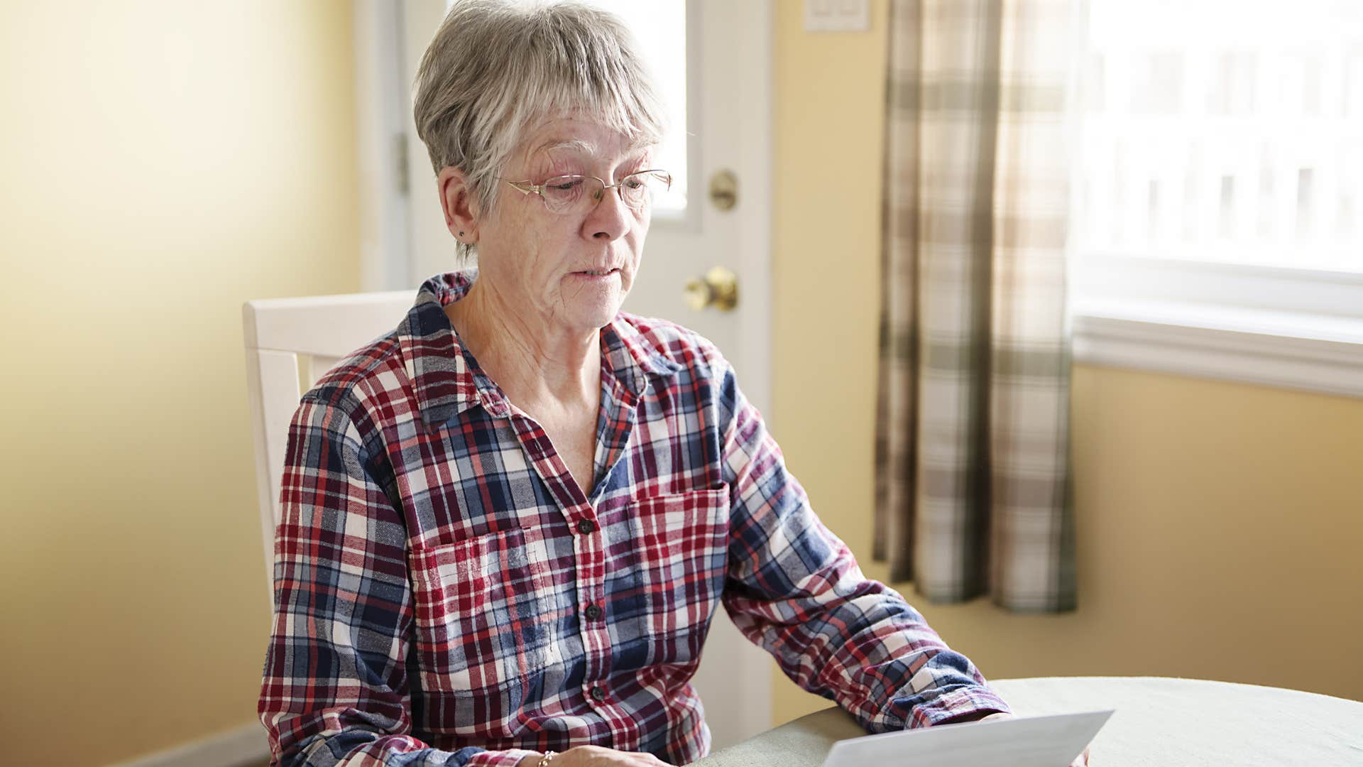 woman who knows convenience should never replace accountability doing bills