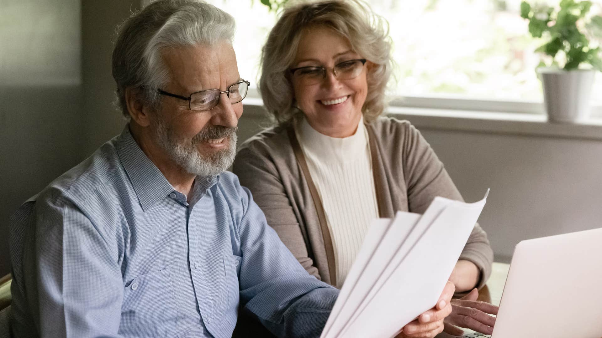 couple who appreciates the importance of privacy smiling at bills