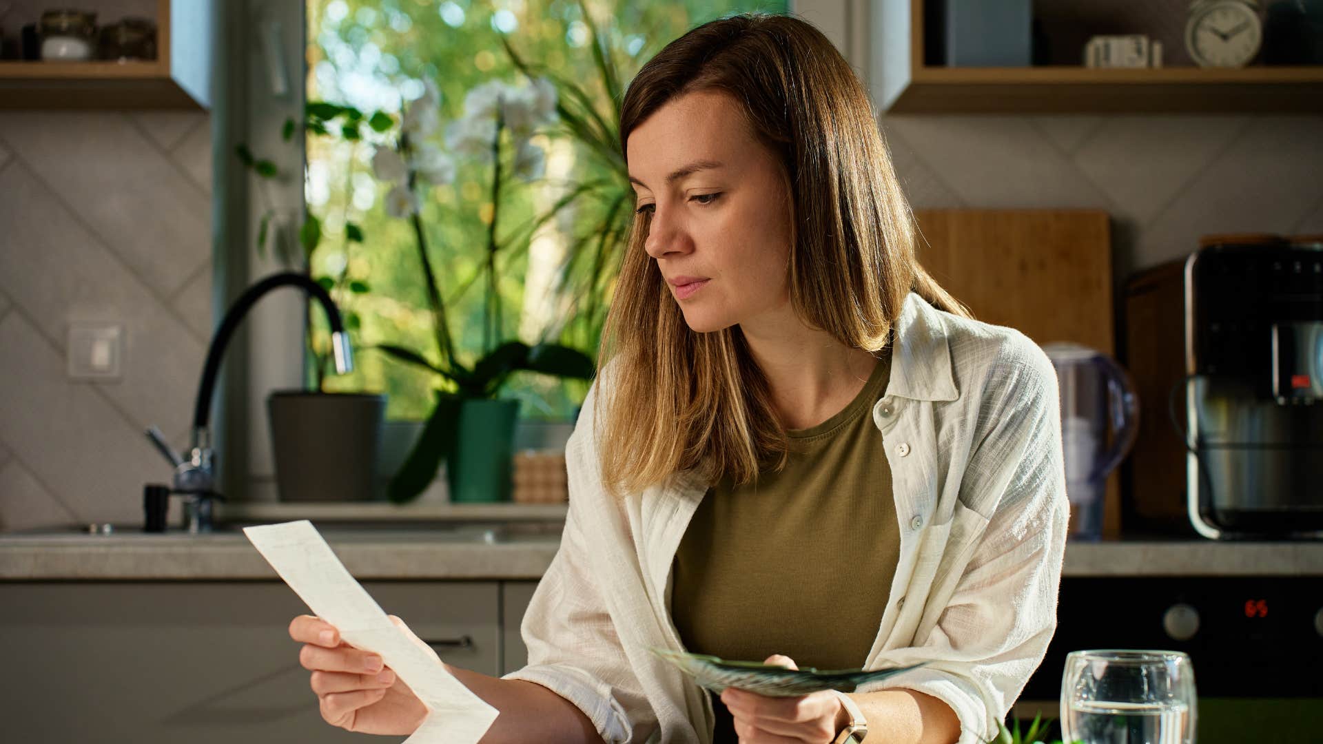 woman looking at receipts doing bills