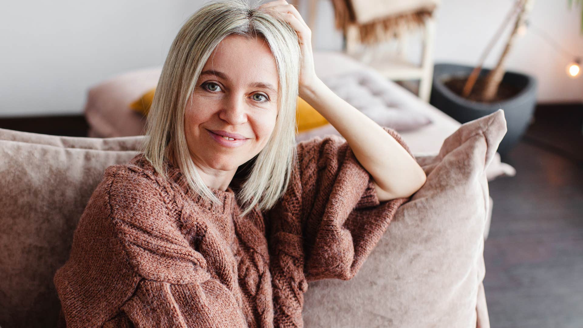 woman leaning into softness smiling