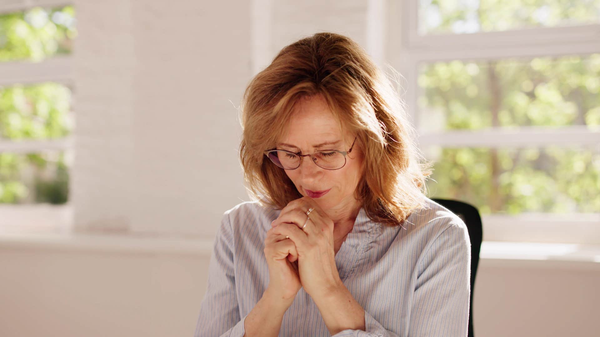 woman praying at home