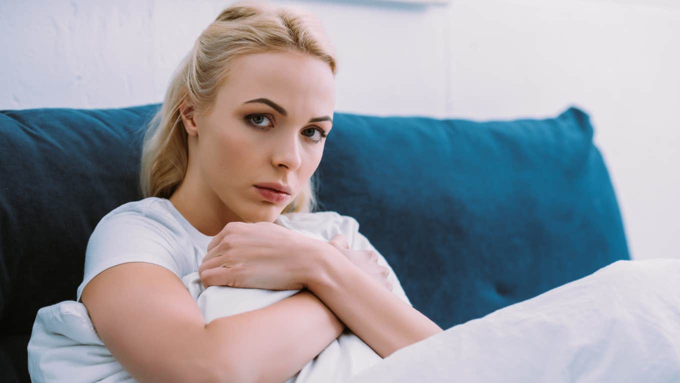 sad woman sitting at home ignoring her family and friends
