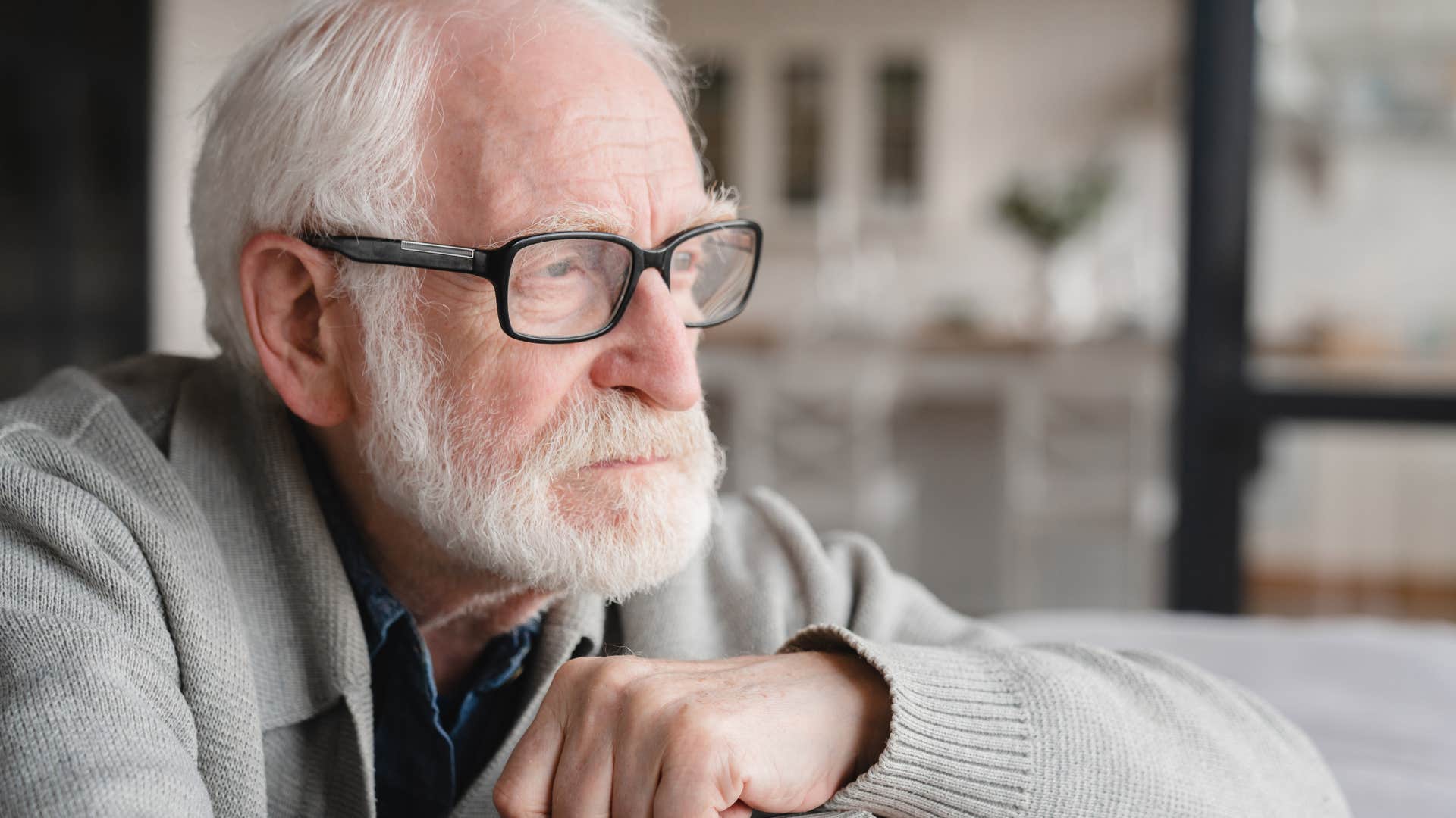 sad man dealing with grief sitting at home