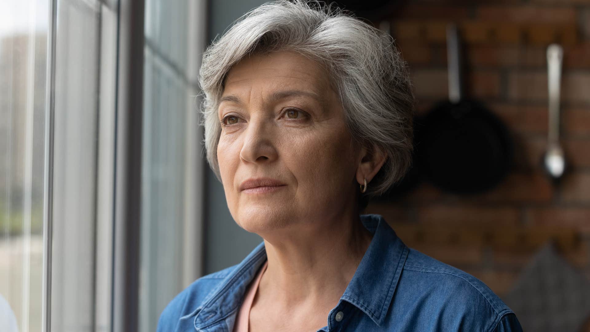 woman protecting her mental health looking out window