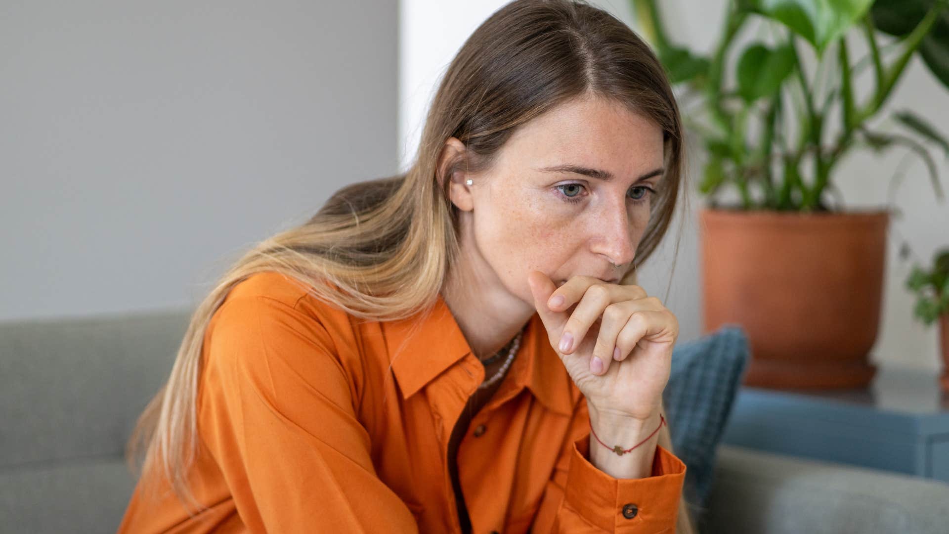 woman actively suppressing her emotions at home