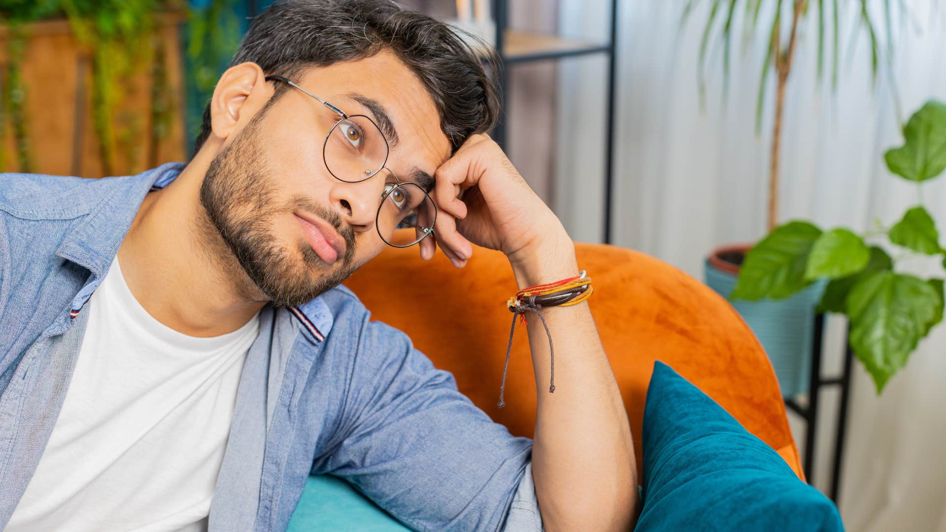 annoyed man sitting on couch