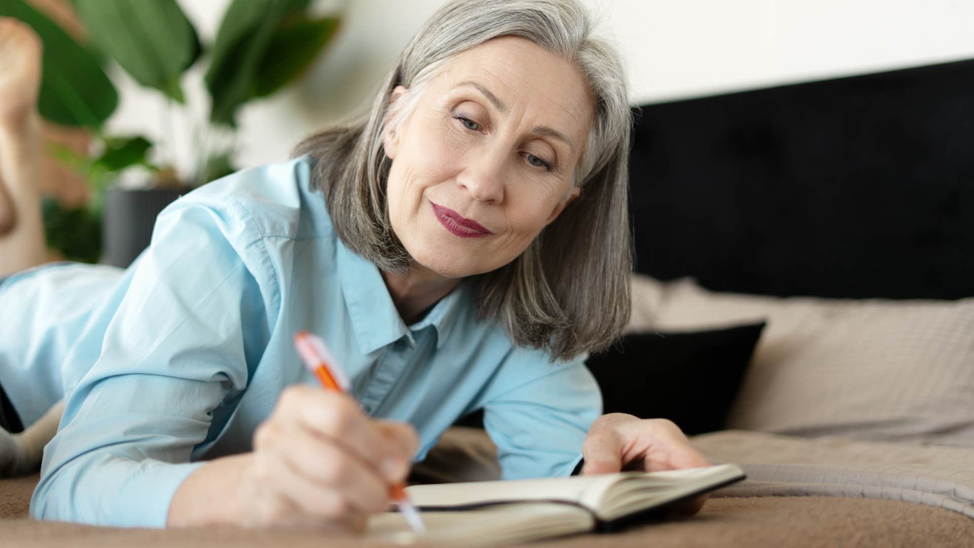 older woman making back-up plans in her notebook