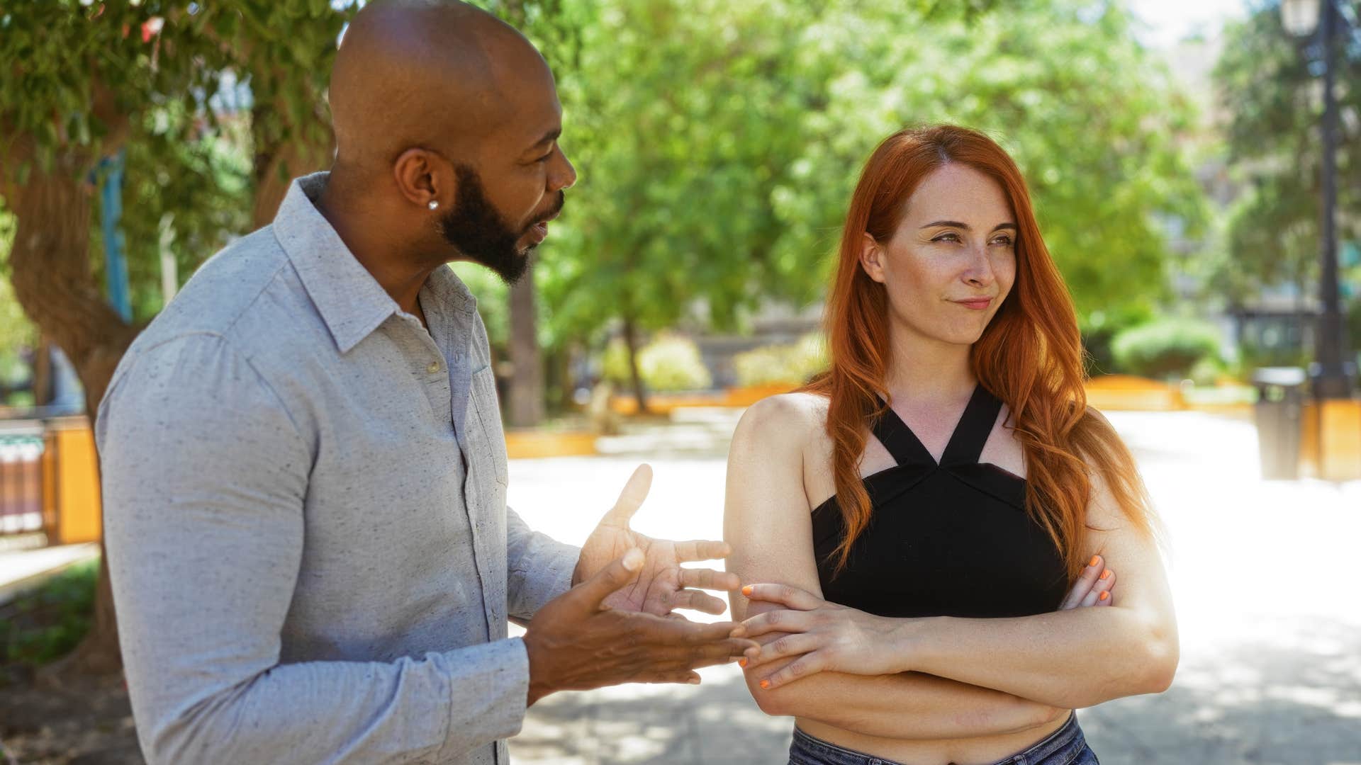 man trying to argue with upset woman outside