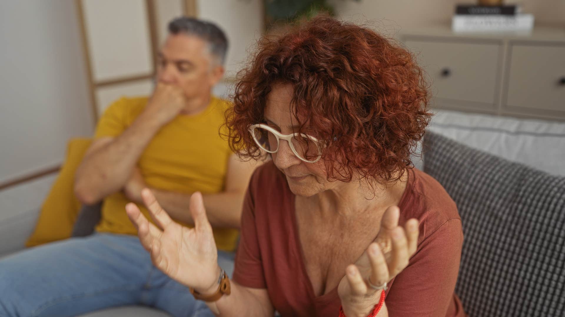 middle-aged couple having serious discussion in living room