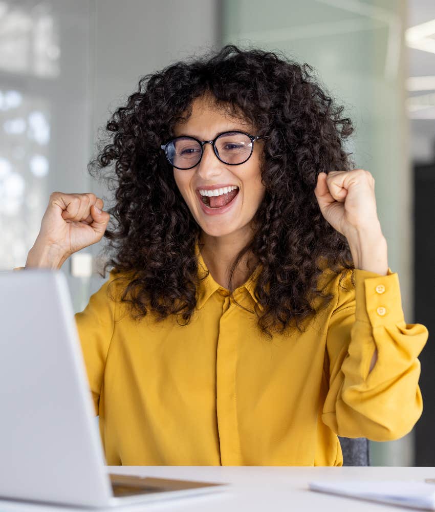 woman celebrating receiving a bonus for her performance