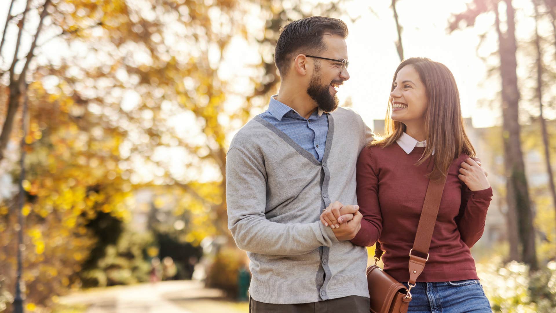 couple holding hands on walk