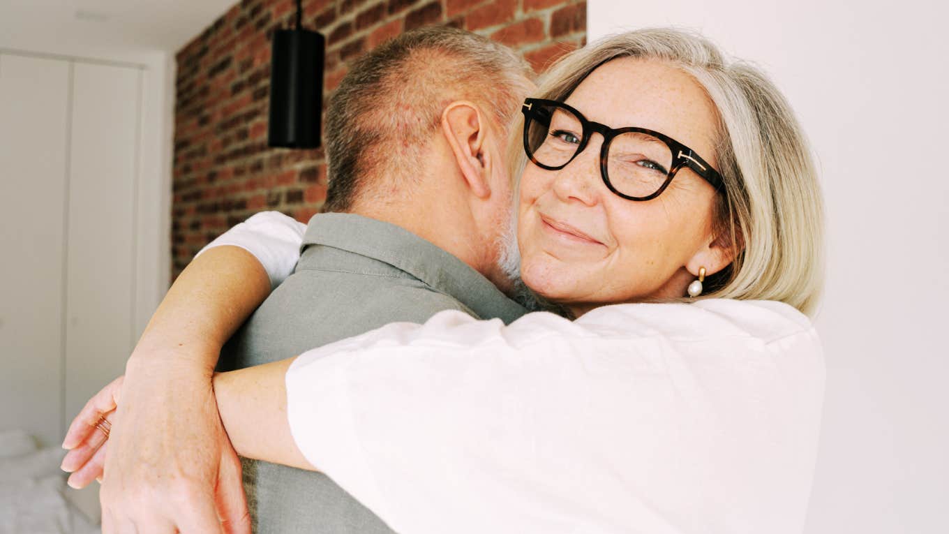 Couple sharing a warm embrace after reconciling, illustrating the gentle phrases and emotional connection of couples who resist big fights.