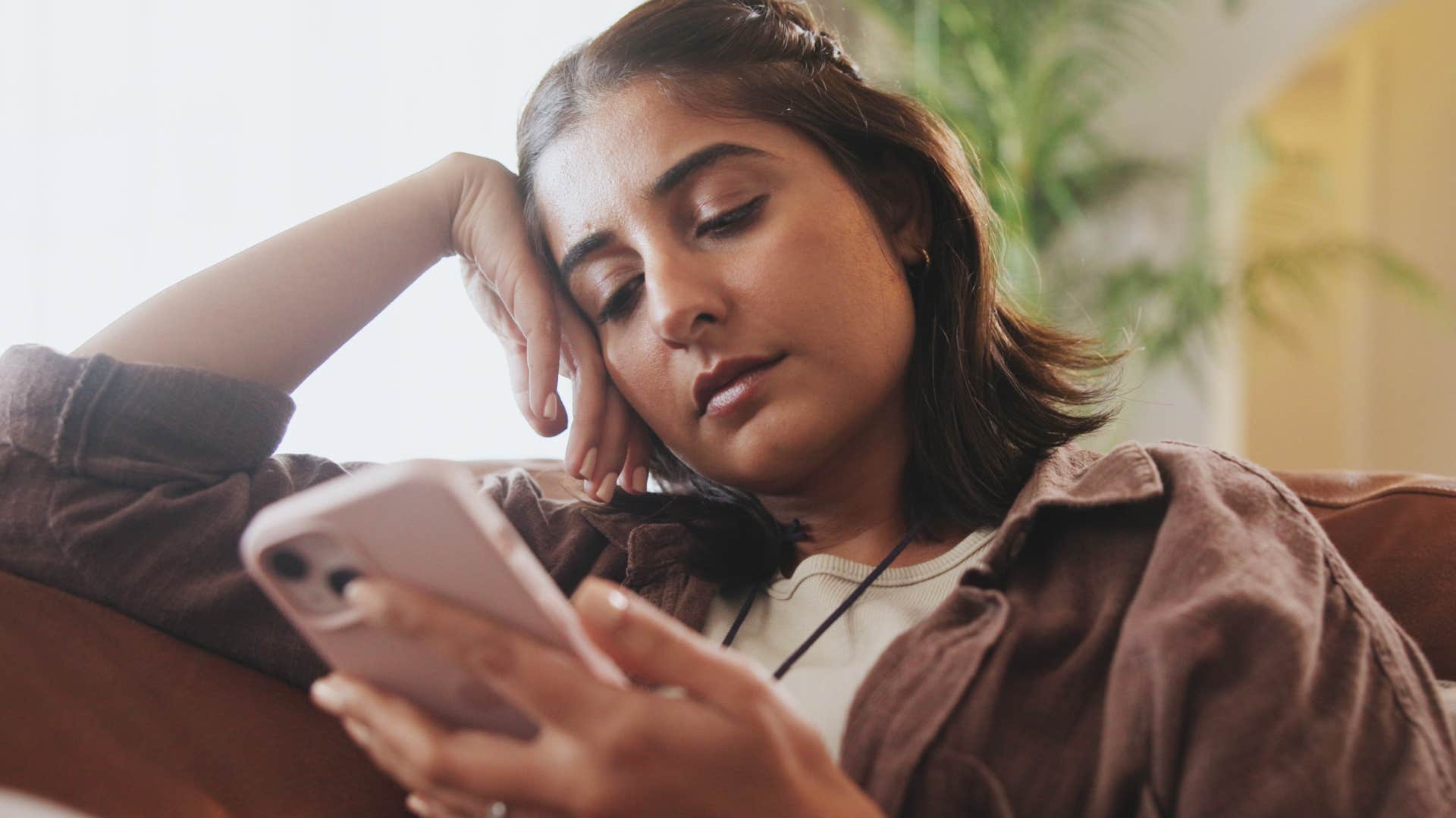 woman looking at phone copying people online