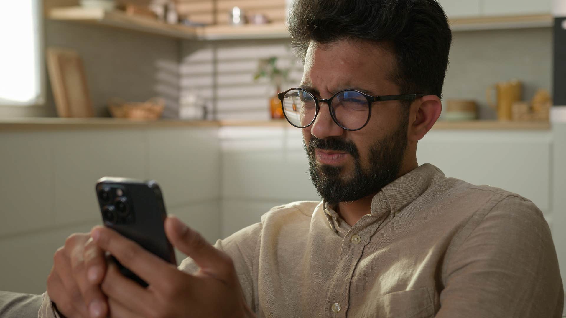 man on his phone using filters to change the way he looks