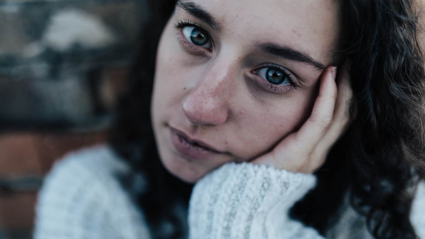 sad woman pretending she's fine even though she's falling apart emotionally